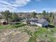 Aerial view of home shows the generous yard, mature trees, exterior, shed, and garden area at 2166 Appaloosa Trl, Elizabeth, CO 80107