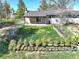 View of a fully-fenced backyard of a home with a sliding glass door and a row of potted plants at 2166 Appaloosa Trl, Elizabeth, CO 80107