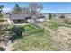 Aerial view showcasing the backyard, with mature trees, lawn, fence, and exterior elements at 2166 Appaloosa Trl, Elizabeth, CO 80107
