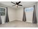 Bright bedroom with large windows and neutral carpet and overhead ceiling fan at 2166 Appaloosa Trl, Elizabeth, CO 80107