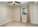 Bright bedroom featuring neutral walls, carpeted floors, a ceiling fan, and a window with curtains at 2166 Appaloosa Trl, Elizabeth, CO 80107