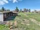 Outdoor structure on a grass field, next to a white house in the distance at 2166 Appaloosa Trl, Elizabeth, CO 80107