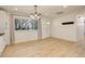 Bright, airy living room with hardwood floors, modern lighting, and a large window at 2166 Appaloosa Trl, Elizabeth, CO 80107