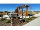 Community park entrance featuring a stone sign and decorative pergola at 28625 E 6Th Pl, Watkins, CO 80137