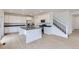Well-lit kitchen featuring stainless steel appliances, an island, and white cabinetry at 28625 E 6Th Pl, Watkins, CO 80137