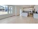 Open-concept kitchen and living area with hardwood floors, a kitchen island, and ample natural light at 28625 E 6Th Pl, Watkins, CO 80137