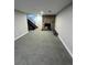Expansive basement featuring a stone fireplace and staircase, offering ample space for entertainment at 528 S Youngfield Ct, Denver, CO 80228