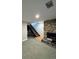 Finished basement featuring a stone fireplace and a staircase with wooden steps and black metal railings at 528 S Youngfield Ct, Denver, CO 80228