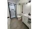 Modern bathroom with a black-framed glass shower, contemporary fixtures, and a vanity with storage at 528 S Youngfield Ct, Denver, CO 80228