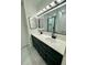 Bathroom with double sink vanity, modern fixtures and a shower in background at 528 S Youngfield Ct, Denver, CO 80228