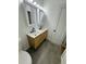 Modern bathroom featuring a double sink vanity with stylish fixtures and a neutral color palette at 528 S Youngfield Ct, Denver, CO 80228