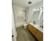Stylish bathroom featuring a shower and tub combo with a double sink vanity and modern fixtures at 528 S Youngfield Ct, Denver, CO 80228