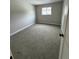Cozy bedroom featuring neutral carpeting and a bright window, ready for personalization at 528 S Youngfield Ct, Denver, CO 80228