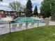 Community pool surrounded by lounge chairs and green grass at 528 S Youngfield Ct, Denver, CO 80228