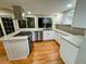 Modern kitchen with white cabinetry, stainless steel appliances, and a center island with a cooktop at 528 S Youngfield Ct, Denver, CO 80228