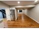 Open living space with hardwood floors and stainless steel refrigerator at 528 S Youngfield Ct, Denver, CO 80228