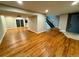 Open-concept living room with beautiful wood floors and sliding glass doors to the backyard at 528 S Youngfield Ct, Denver, CO 80228