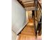 Hardwood staircase featuring black metal railing and a stone wall accent, viewed from the top at 528 S Youngfield Ct, Denver, CO 80228