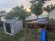 Backyard with storage shed, playground equipment, wooden fence and mature trees at 3220 W 133Rd Cir, Broomfield, CO 80020