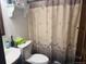 Bathroom features a toilet, sink and shower with decorative shower curtain at 3220 W 133Rd Cir, Broomfield, CO 80020