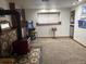 Spacious game room offers natural light, game machine, wood burning stove, and carpet floors at 3220 W 133Rd Cir, Broomfield, CO 80020