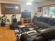 Inviting living room featuring a large sectional, entertainment center, and cozy rug at 3220 W 133Rd Cir, Broomfield, CO 80020