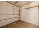 Unfinished basement with wood floors and partial shelving providing ample storage or customization potential at 3581 Gap Rd, Golden, CO 80403
