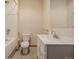 Bathroom featuring a white vanity, toilet, tub, shower with tile surround and neutral flooring at 3581 Gap Rd, Golden, CO 80403