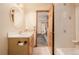Bathroom featuring vanity with storage and walk in shower with decorative accent tile at 3581 Gap Rd, Golden, CO 80403