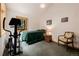 Cozy bedroom featuring a comfortable bed, exercise machine, and a large window with natural light at 3581 Gap Rd, Golden, CO 80403