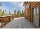 Wrap around deck on a log home offers outdoor space with wooded views at 3581 Gap Rd, Golden, CO 80403
