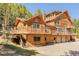Beautiful log home featuring multiple decks and an attached two-car garage, nestled in a scenic landscape at 3581 Gap Rd, Golden, CO 80403