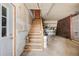 Garage features stairs, concrete flooring, and shelving providing space for parking and storage at 3581 Gap Rd, Golden, CO 80403