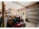 Garage features garage door, open studs, workbench, and a door to the backyard at 3581 Gap Rd, Golden, CO 80403