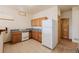 Classic kitchen features wood cabinets, standard appliances, and a window for natural lighting at 3581 Gap Rd, Golden, CO 80403