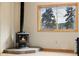 Living room featuring a fireplace and a window overlooking the trees at 3581 Gap Rd, Golden, CO 80403