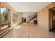 Bright, open-concept living space featuring large windows, wood accents, and a staircase at 3581 Gap Rd, Golden, CO 80403