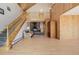 Spacious living room featuring a stone fireplace, vaulted ceilings, and a wooden staircase at 3581 Gap Rd, Golden, CO 80403