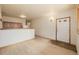 Bright living room features wood floors, warm lighting, and a half wall to the kitchen area at 3581 Gap Rd, Golden, CO 80403