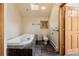 Well-lit bathroom with a skylight, jetted tub, and marble flooring at 3581 Gap Rd, Golden, CO 80403