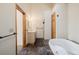 Luxurious bathroom featuring marble floors, a jacuzzi tub, and wood trim at 3581 Gap Rd, Golden, CO 80403