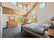 Vaulted main bedroom features natural light, a wood ceiling, and an exterior door to a private deck at 3581 Gap Rd, Golden, CO 80403