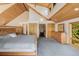 Bright main bedroom features vaulted wood ceiling, multiple windows, and a private ensuite bathroom at 3581 Gap Rd, Golden, CO 80403