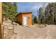 The outbuilding offers versatile space surrounded by natural landscape and mature trees at 3581 Gap Rd, Golden, CO 80403