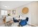 Bright dining area with a round table and four blue velvet chairs at 4336 Decatur St, Denver, CO 80211