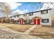 Three-unit building with red doors and landscaping at 4336 Decatur St, Denver, CO 80211