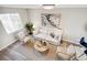 Living room featuring a beige sofa and two armchairs at 4336 Decatur St, Denver, CO 80211