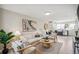 Open living room featuring a light beige sofa and wooden coffee table at 4336 Decatur St, Denver, CO 80211