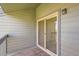 Balcony features gray siding and sliding glass door at 3558 S Depew St # 302, Denver, CO 80235