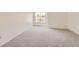 Bright, carpeted bedroom with a large window bringing in natural light at 3558 S Depew St # 302, Denver, CO 80235